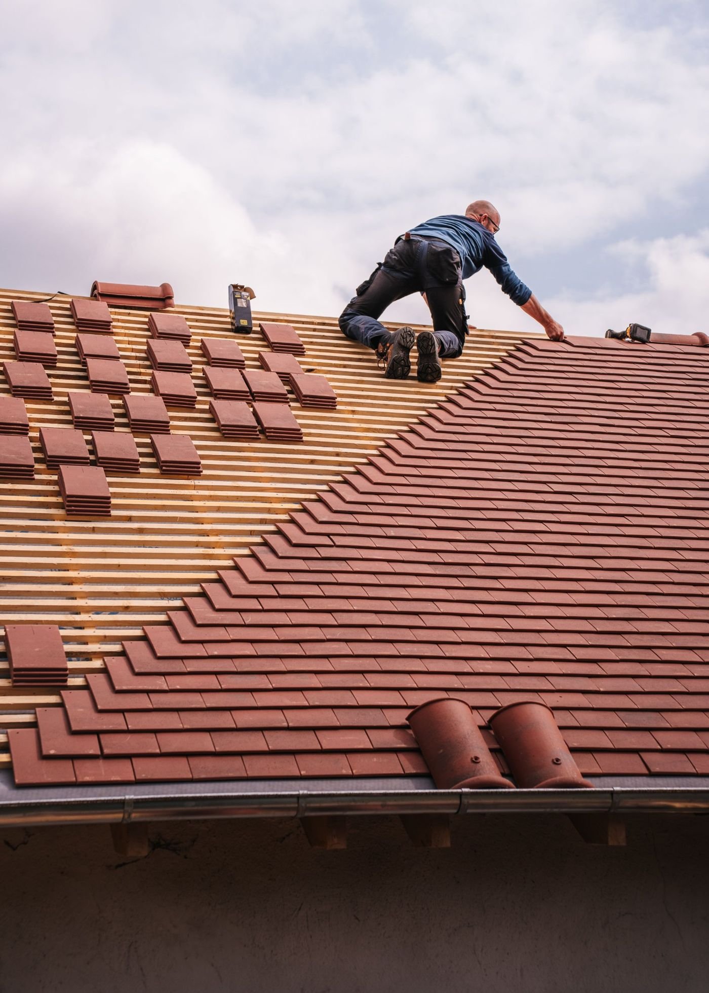 Professional roofer installing shingles on a residential roof